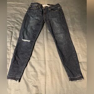 J. Crew toothpick jeans in dark wash. Rips at knees. Frayed hems. Size 32